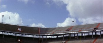 Movie still from “Black Sunday” (1977), directed by John Frankenheimer – An image of an empty bleachers in a stadium; Extreme Wide shot, Low angle