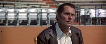 Movie still from “Black Sunday” (1977), directed by John Frankenheimer – A person wearing a leather jacket; Close Up shot, Low angle