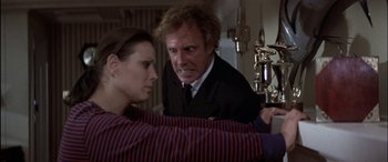 Movie still from “Black Sunday” (1977), directed by John Frankenheimer – A man and a woman are looking at each other; Medium shot, Over the shoulder angle