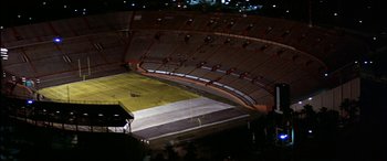 Movie still from “Black Sunday” (1977), directed by John Frankenheimer – An empty football stadium at night with no fans; Extreme Wide shot, High angle