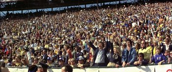 A large crowd of people in a stadium watching a baseball game