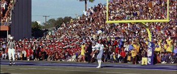 Movie still from “Black Sunday” (1977), directed by John Frankenheimer – A crowd of people watching a football game in front of an audience; Extreme Wide shot, High angle