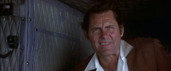 Movie still from “Black Sunday” (1977), directed by John Frankenheimer – An older man wearing a white shirt and a brown jacket; Close Up shot, Low angle