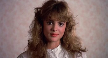 Movie still from “Blame It on Rio” (1984), directed by Stanley Donen – A young woman with long , blonde hair wearing a white shirt; Close Up shot, Low angle