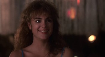 Movie still from “Blame It on Rio” (1984), directed by Stanley Donen – A person smiling; Close Up shot, Over the shoulder angle