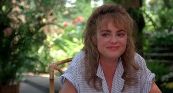 Movie still from “Blame It on Rio” (1984), directed by Stanley Donen – A person sitting in a chair; Close Up shot, Over the shoulder angle