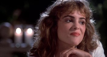 Movie still from “Blame It on Rio” (1984), directed by Stanley Donen – A person with long curly hair; Close Up shot, Low angle