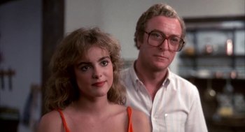 Movie still from “Blame It on Rio” (1984), directed by Stanley Donen – A man and a woman standing next to each other in a room; Close Up shot, Over the shoulder angle