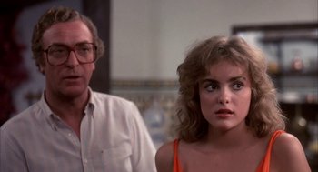 Movie still from “Blame It on Rio” (1984), directed by Stanley Donen – A man and a woman standing next to each other in a room; Close Up shot, Over the shoulder angle