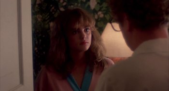 Movie still from “Blame It on Rio” (1984), directed by Stanley Donen – A woman in a pink robe looking at a man in a blue shirt; Close Up shot, Over the shoulder angle