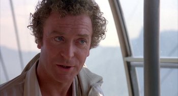 Movie still from “Blame It on Rio” (1984), directed by Stanley Donen – A person with curly hair; Close Up shot, Low angle