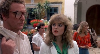 Movie still from “Blame It on Rio” (1984), directed by Stanley Donen – A woman in a white jacket standing in front of a crowd; Close Up shot, Over the shoulder angle