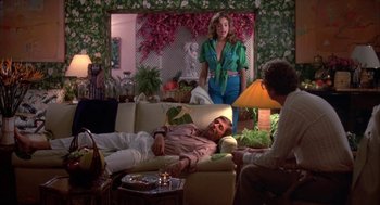 Movie still from “Blame It on Rio” (1984), directed by Stanley Donen – A group of people sitting on a couch in a living room; Wide shot, High angle