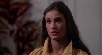 Movie still from “Blame It on Rio” (1984), directed by Stanley Donen – A woman with long hair wearing a yellow shirt; Close Up shot, Over the shoulder angle