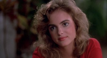 Movie still from “Blame It on Rio” (1984), directed by Stanley Donen – A person wearing a red shirt; Close Up shot, Over the shoulder angle
