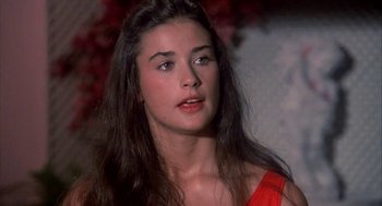 Movie still from “Blame It on Rio” (1984), directed by Stanley Donen – A person with long hair; Close Up shot, High angle