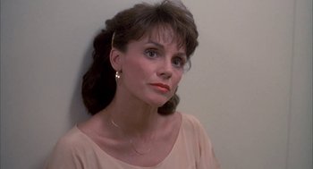 Movie still from “Blame It on Rio” (1984), directed by Stanley Donen – A person wearing a dress; Close Up shot, Over the shoulder angle