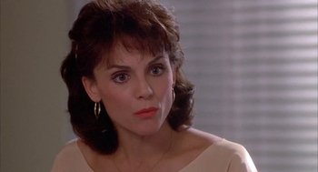 Movie still from “Blame It on Rio” (1984), directed by Stanley Donen – A person wearing a dress; Close Up shot, Over the shoulder angle