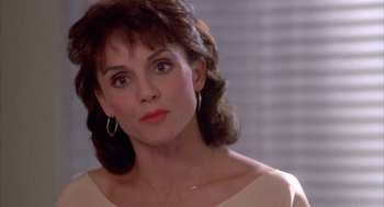 Movie still from “Blame It on Rio” (1984), directed by Stanley Donen – A person wearing a dress; Close Up shot, Over the shoulder angle