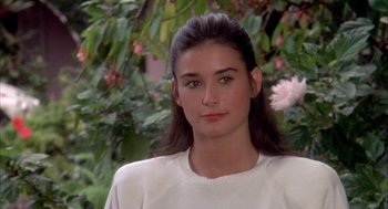 Movie still from “Blame It on Rio” (1984), directed by Stanley Donen – A woman with long black hair wearing a white shirt; Close Up shot, High angle