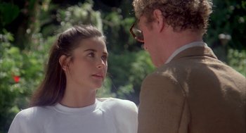 Movie still from “Blame It on Rio” (1984), directed by Stanley Donen – A man and a woman are standing next to each other; Close Up shot, Over the shoulder angle