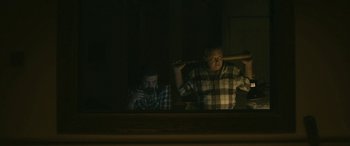 Movie still from “Blaze” (2018), directed by Ethan Hawke – Two men sitting in front of each other in front of a window; Medium shot, Over the shoulder angle