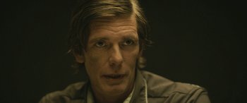 Movie still from “Blaze” (2018), directed by Ethan Hawke – A person with long hair; Close Up shot, Over the shoulder angle