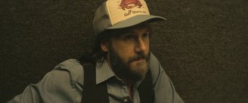 Movie still from “Blaze” (2018), directed by Ethan Hawke – A man with a beard wearing a hat; Close Up shot, High angle