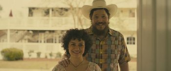 Movie still from “Blaze” (2018), directed by Ethan Hawke – A man and a woman standing next to each other; Close Up shot, High angle