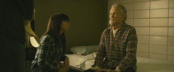 Movie still from “Blaze” (2018), directed by Ethan Hawke – An older man and a young woman sitting on a bed; Medium shot, Over the shoulder angle