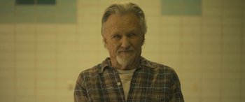 Movie still from “Blaze” (2018), directed by Ethan Hawke – An older man with a beard and a plaid shirt; Close Up shot, High angle