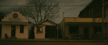 Movie still from “Blaze” (2018), directed by Ethan Hawke – An old house is sitting on the side of the road; Extreme Wide shot, Low angle