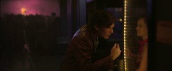 Movie still from “Blaze” (2018), directed by Ethan Hawke – A man in brown jacket leaning on a table; Medium shot, Over the shoulder angle