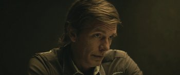 Movie still from “Blaze” (2018), directed by Ethan Hawke – A person with long hair; Close Up shot, Over the shoulder angle