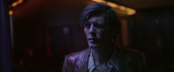 Movie still from “Blaze” (2018), directed by Ethan Hawke – A man in a leather jacket looking to his left; Close Up shot, Low angle