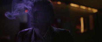 Movie still from “Blaze” (2018), directed by Ethan Hawke – A man is smoking a cigarette in a dark room; Close Up shot, Low angle