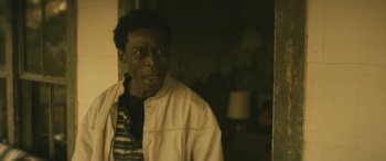 Movie still from “Blaze” (2018), directed by Ethan Hawke – A man in a white jacket standing in front of a mirror; Close Up shot, Over the shoulder angle