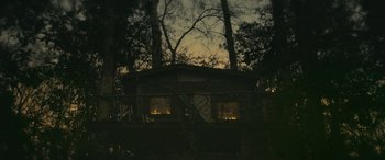 Movie still from “Blaze” (2018), directed by Ethan Hawke – A house in the middle of the night with lights on the windows; Extreme Wide shot, Low angle