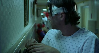 Movie still from “Blind Horizon” (2003), directed by Michael Haussman – A man wearing a blindfold is playing a video game; Close Up shot, Low angle