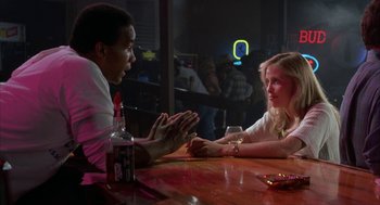 Movie still from “Blood Simple” (1984), directed by Joel Coen – A man and a woman sitting at a table talking to each other; Medium shot, Over the shoulder angle