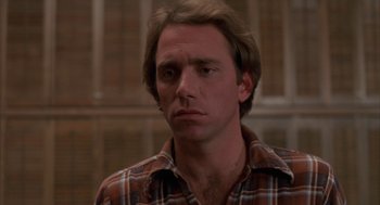 Movie still from “Blood Simple” (1984), directed by Joel Coen – A person wearing a plaid shirt; Close Up shot, Low angle