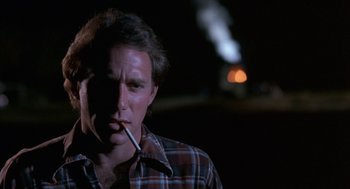 Movie still from “Blood Simple” (1984), directed by Joel Coen – A man is smoking a cigarette in the dark; Close Up shot, Low angle