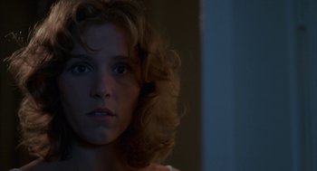 Movie still from “Blood Simple” (1984), directed by Joel Coen – A person with curly blonde hair; Close Up shot, Over the shoulder angle