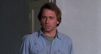 Movie still from “Blood Simple” (1984), directed by Joel Coen – A person wearing a blue shirt; Close Up shot, Low angle