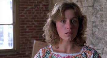 Movie still from “Blood Simple” (1984), directed by Joel Coen – A young woman is looking into the camera; Close Up shot, Low angle
