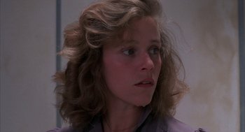 Movie still from “Blood Simple” (1984), directed by Joel Coen – A young woman with long hair looking to her left; Close Up shot, Low angle