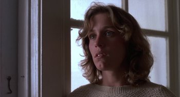 Movie still from “Blood Simple” (1984), directed by Joel Coen – A person with long curly hair; Close Up shot, Low angle