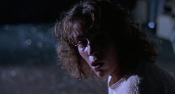 Movie still from “Blood Simple” (1984), directed by Joel Coen – A person wearing a white sweater; Close Up shot, Low angle