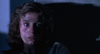 Movie still from “Blood Simple” (1984), directed by Joel Coen – A young woman with a towel around her neck; Close Up shot, Low angle