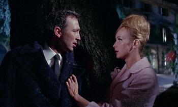 Movie still from “Blood and Black Lace” (1964), directed by Mario Bava – A man and a woman are standing next to each other; Close Up shot, High angle